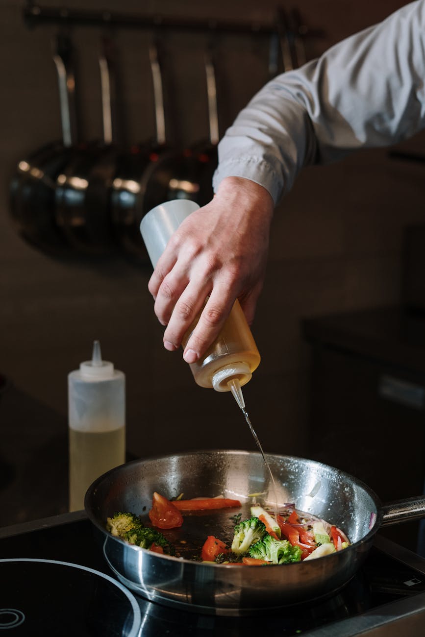 person holding stainless steel bowl with yellow handle